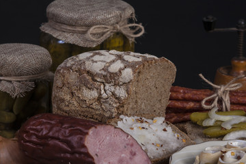  still-life with dark bread,  snack stick sausage and herrings