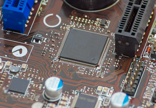 Fragment of electronic board with chip in center closeup