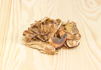 Small pile of dried boletus on a wooden surface