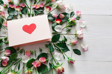 Valentine day background, heart card and flowers on white wood