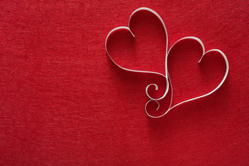 Valentine day background, handmade paper hearts on red felt