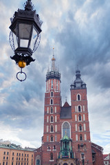 Fototapeta na wymiar Church of St. Mary in the main Market Square on the background of dramatic sky. Basilica Mariacka. Krakow. Poland.