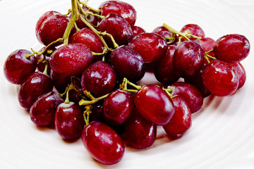 Red grapes with water drops .