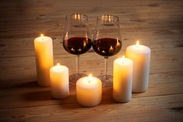 Wine with candles on wooden background