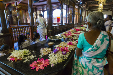 Temple Of The Sacred Tooth RelicThe inside view. People bring flowers to the Temple. Kandy, Sri Lank