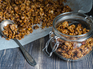 Open glass jar with homemade granola 
