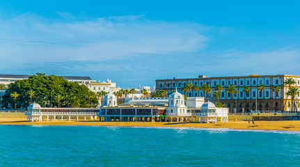 view of la caleta beach with white building of an old bathhouse in the spanish city cadiz © dudlajzov