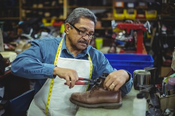 Shoemaker repairing a shoe