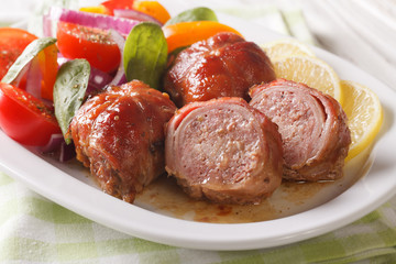 Baked rabbit fillet and salad of tomatoes, peppers, spinach and onion close-up. horizontal