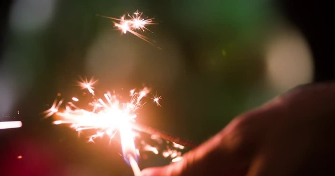 Set fire sparkler with strike a match HD close-up slow motion video background. Burning firework flames sparks. Merry Christmas and Happy New year greeting card template