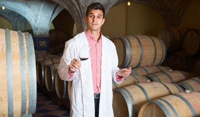Obraz na płótnie Canvas taster of winery posing with wine
