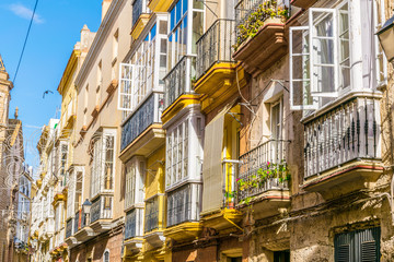 view of a row of balconies on a narrow street in historical center of spanish city cadiz © dudlajzov