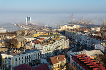 top view of the center of the historical part of Odessa and the Odessa sea port on a sunny day with fog.