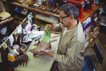 Shoemaker repairing a shoe sole
