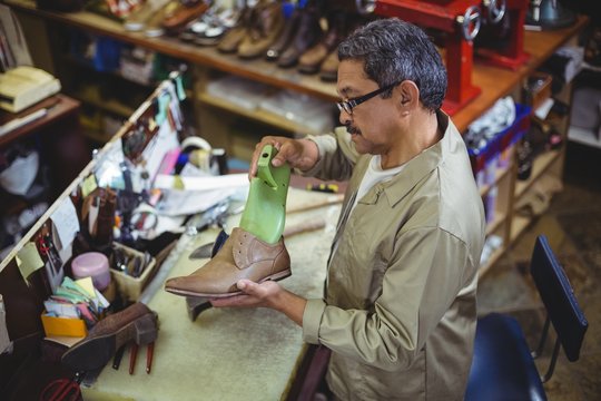 Shoemaker Repairing A Shoe Sole