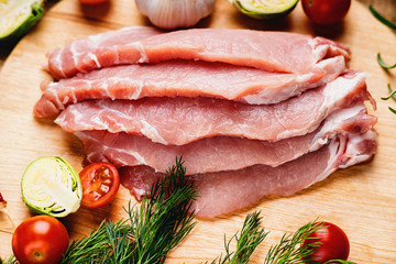 Slices of raw pork meat and vegetables 