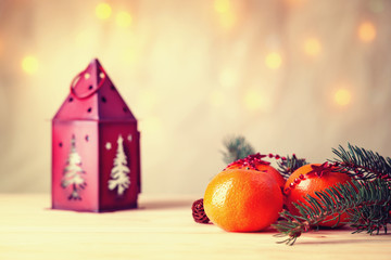 Mandarins with fir-tree branch and house shaped candlestick 