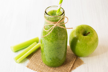 Healthy green celery smoothie in bottle
