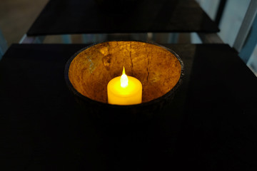 Light candle in the coconut shell in the dark night