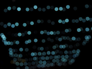 Blue light bulb and bokeh on the dark background