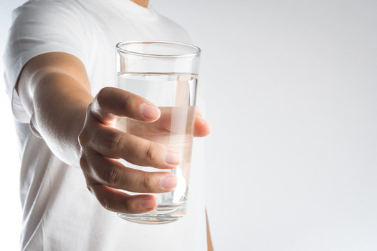 Hand holding a glass of water