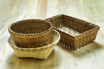 Wicker bamboo baskets on wooden table