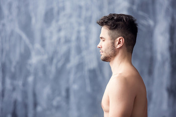 Portrait of handsome man doing yoga and meditation
