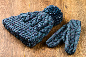 Fototapeta na wymiar gray knitting cap and mittens