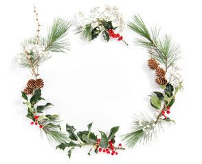 Frame pine tree branches ilex leaves Christmas floral flat lay