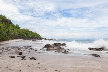 Waves crashing to rocks montezuma beach