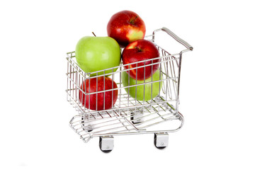 Giant apples in a shopping trolley on white background