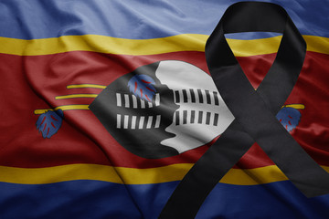 flag of swaziland with black mourning ribbon © luzitanija
