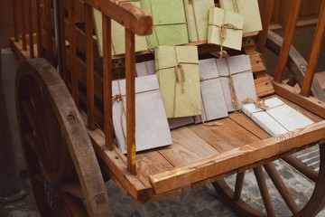Vintage gifts concept. Old wooden carriage with books wrapped in paper