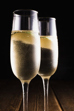 Glasses filled with champ with piece of lime