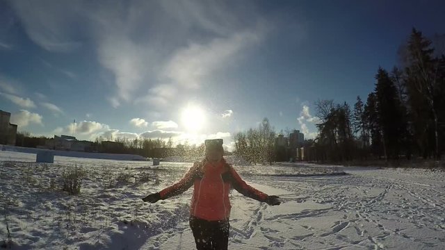 Woman Thowing up Snow and Smiling