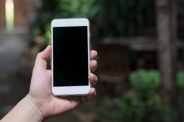 using smart phone in cafe. hand holding smart phone white screen