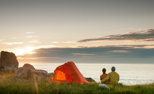 couple camping with tent near seaside