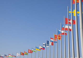 Flags of different countries on the flagpole