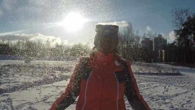 Woman Throwing up Snow Opposite the Sun