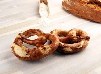 Different kinds of bread rolls on white board from above. Kitchen or bakery poster design.