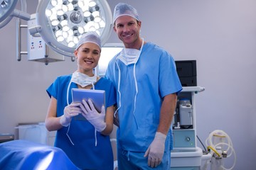 Male and female nurse using digital tablet in operation theater