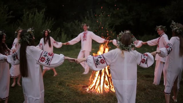 Midsummer. Young people in Slavic clothes revolve around a fire in the Midsummer.