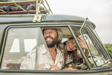 Young couple heads of in their old classic combi van.