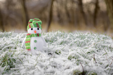 funny snowman standing on snow meadow