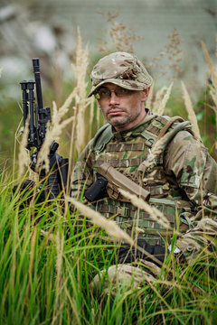 Portrait soldier or private military contractor holding sniper 