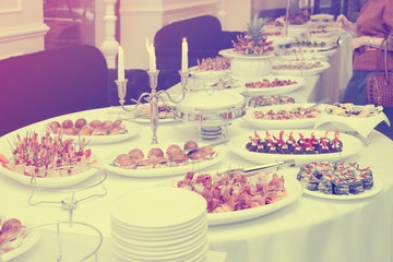 Meat and fish appetizers in a restaurant, toned
