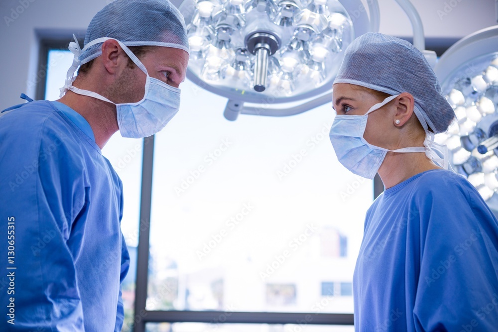 Poster surgeons interacting with each other in operation theater