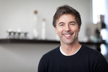 Obraz premium Portrait Of A Mature Handsome Man Smiling At The Camera. Home. Kitchen