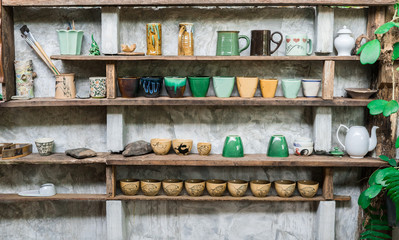 Fototapeta premium Ceramic cup on shelf cement background