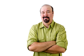 Grinning middle aged man with folded arms on white